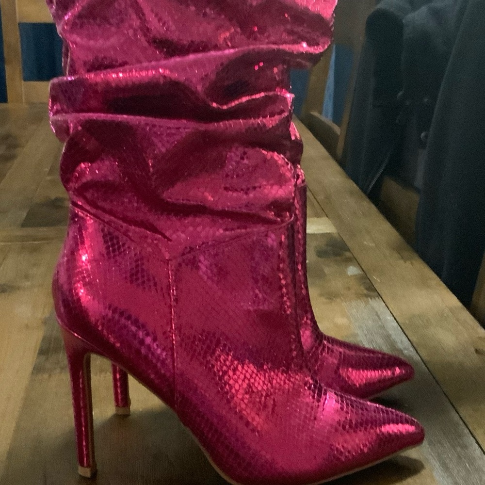 Pink shiny slouch boot heels.